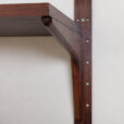 rosewood wall unit with a desk and display shelf mounted on veneered metal rails scaled