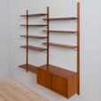 Danish teak wall unit with sliding door cabinet and  shelves in the style of Kurt Ostervig s