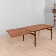 Rectangular teak dining table with hidden extension leaves by Johannes Andersen
