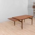 Rectangular teak dining table with hidden extension leaves by Johannes Andersen