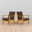 Pair of oak GE Hans Wegner easy lounge chairs in original upholstery Denmark s