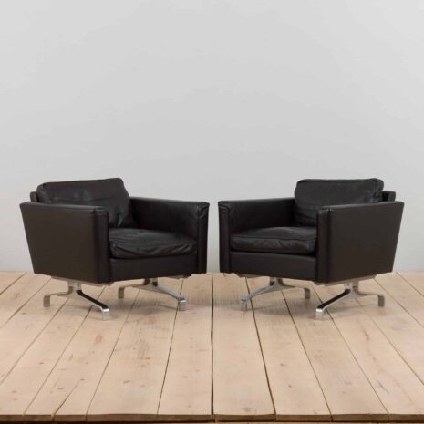 a pair of leather armchairs