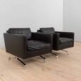 a pair of leather armchairs