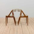 a pair of teak chairs