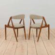 a pair of teak chairs