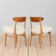 Pair of oak dining chairs in the style of Hans Wegner in long hair sheepskin Denmark s