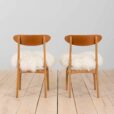 Pair of oak dining chairs in the style of Hans Wegner in long hair sheepskin Denmark s