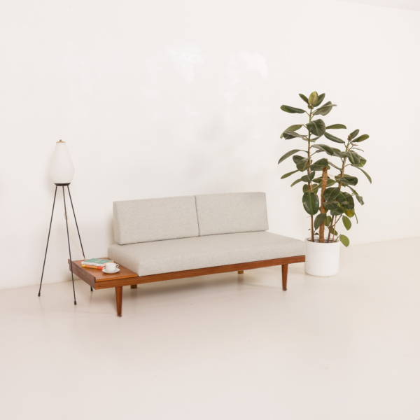 This Scandinavian mid-century Svane daybed by Ignar Relling features clean lines, a light grey wool upholstery, and a warm wooden frame with an integrated side table. Its timeless design and smart functionality bring a calm, Nordic elegance to any interior.