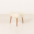 Scandinavian-mid-century-triangular-footstool-in-long-hair-sheepskin-Denmark-1960s